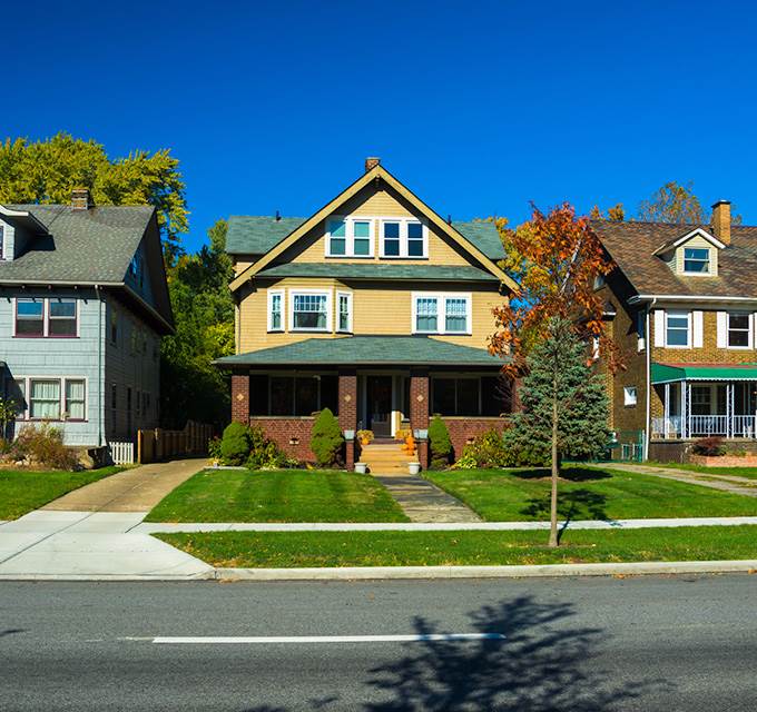 A yellow house on a suburban street